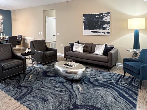 a living room with couches and chairs and a rug at Canebrake Apartment Homes in Shreveport, LA, 71115